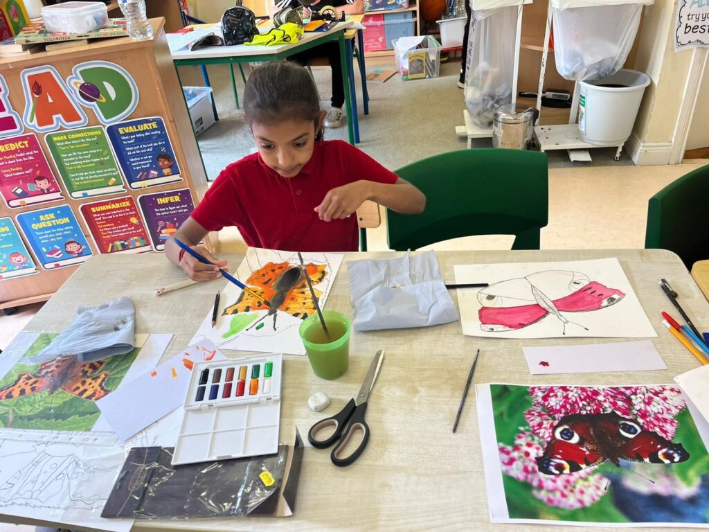 Photo 1: Samratchana, a 2nd Class pupil in Kilteevan NS, Roscommon, working on her painting of the Comma Butterfly as part of the Tóchar Stories/Kilteevan Tidy Towns nature creativity project (Photo Annie Holland).