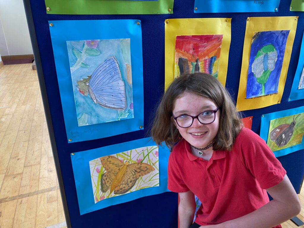 Ruth posing beside her painting