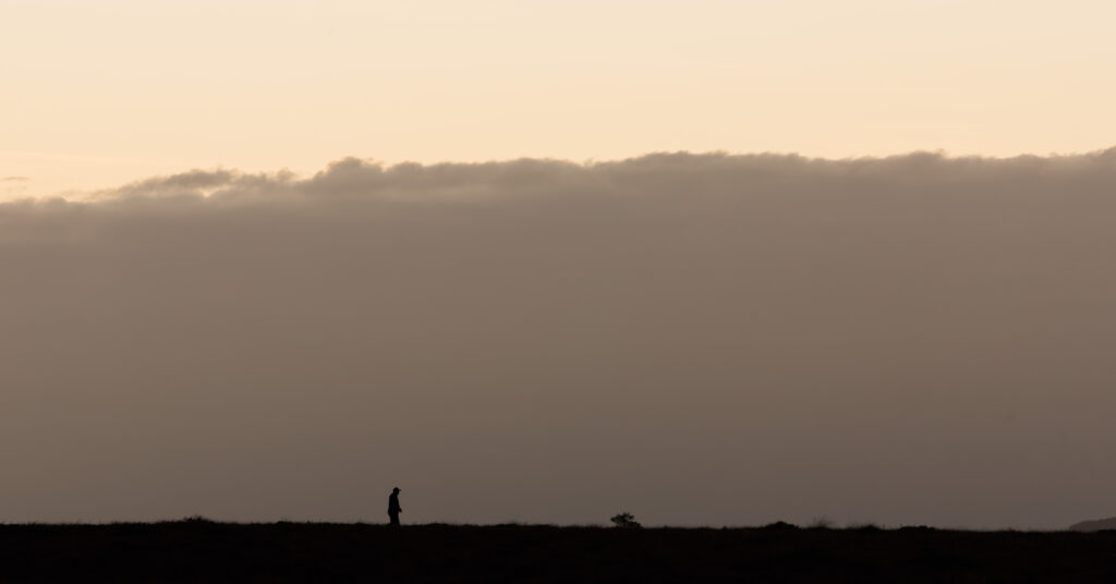 A person standing silhouetted on the horizon of Clara Bog, Co Offaly