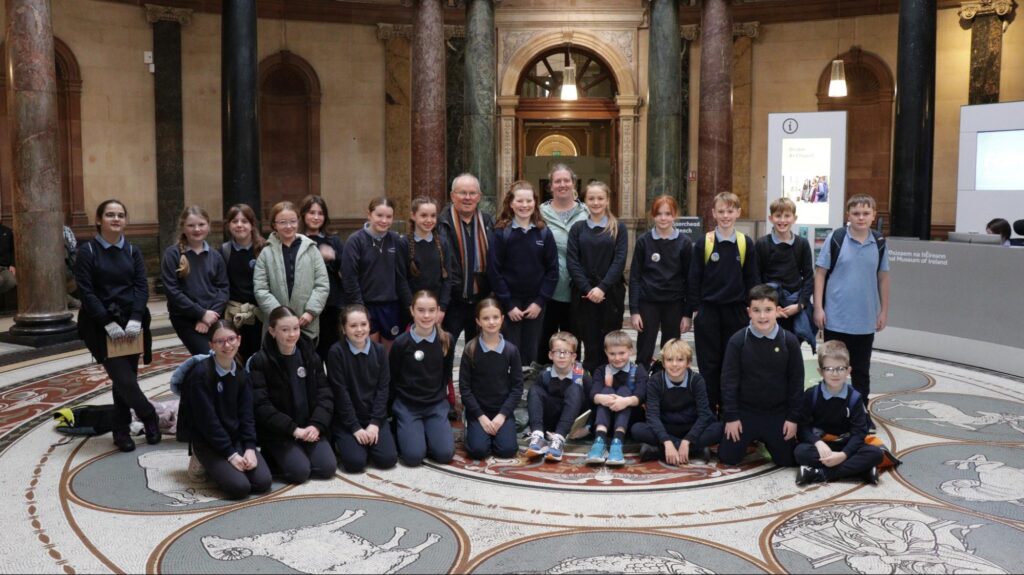 Photograph of Photo: St Anne’s National School, 5th Class with Eugene and teacher, Laura inside the National Museum. Credit Stephen Crilly (Tóchar Stories).