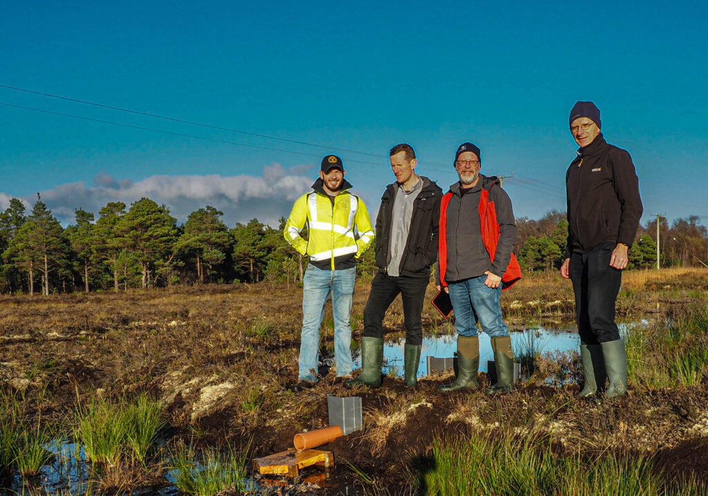 Photo of Brian Gorman, peatland contractor, James Grennan, owner of Clonbeale More Bog, George Smith, ecologist from Blackthorn Ecology and Michael Carroll from Tullamore Lions Club on Clonbeale More Bog following the completion of restoration work on the site in November.