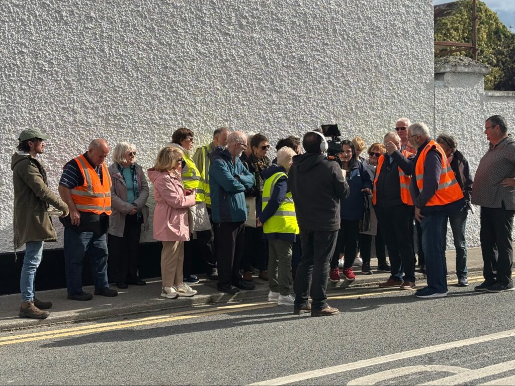 Photograph of Community group in Kilcormac, with volunteer leaders Sean Craven and Seamus Barron in orange jackets, leading Tóchar Stories and Kilcormac Development Association guided heritage walk in September