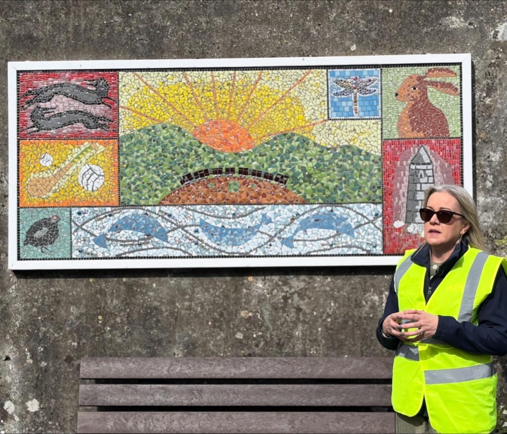 Photograph of Linda Kelly, KDA at the community mural at the end of the community walk in September