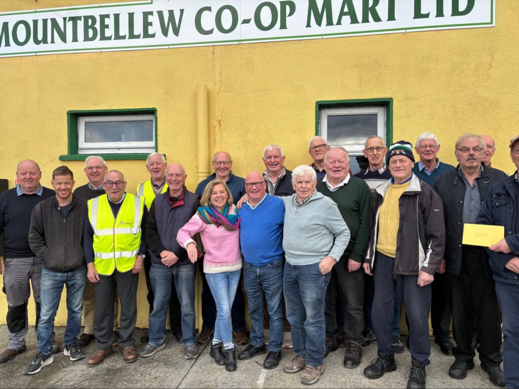 Photograph of Helen Shaw, Tóchar Stories, with members of the Mountbellew Men’s Shed