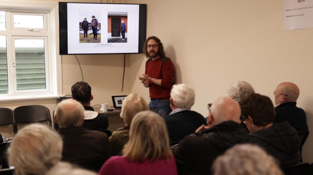 Photograph of artist Shane Hynan presenting his work in Carbury Community Centre 