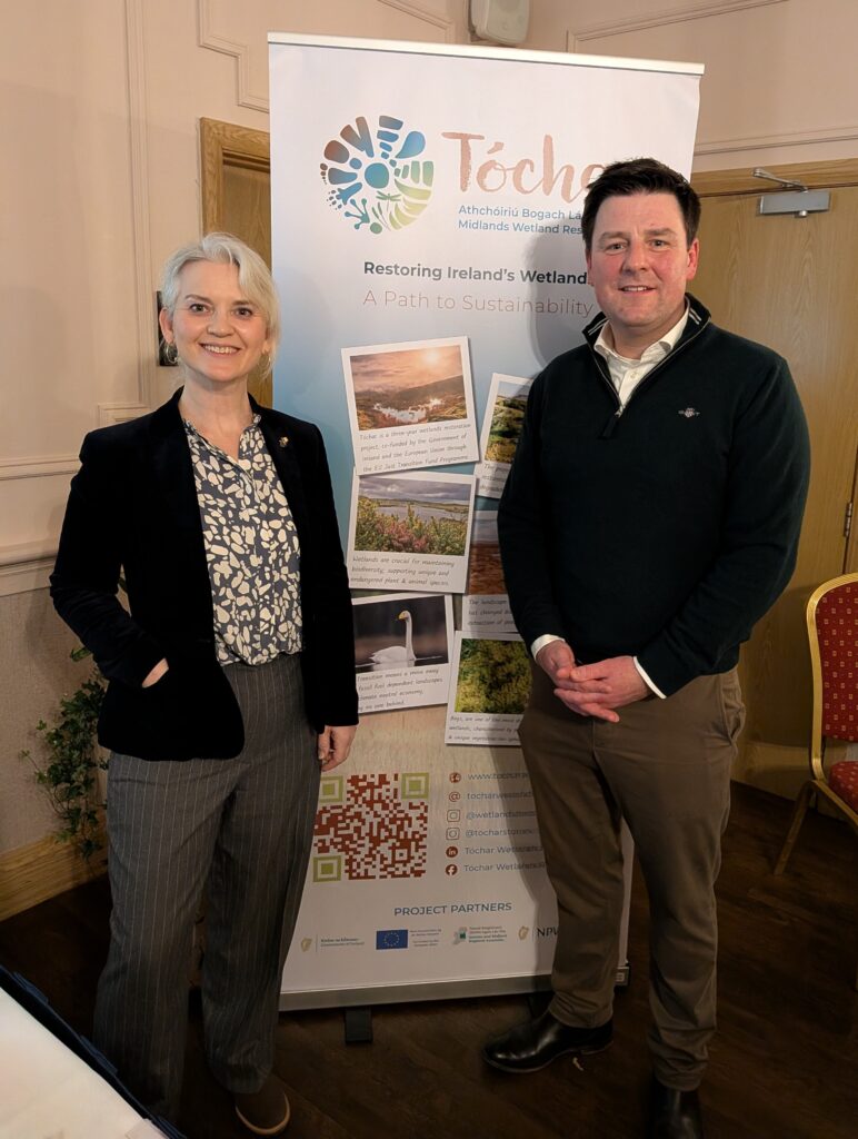 Man and woman standing in front of pull up.