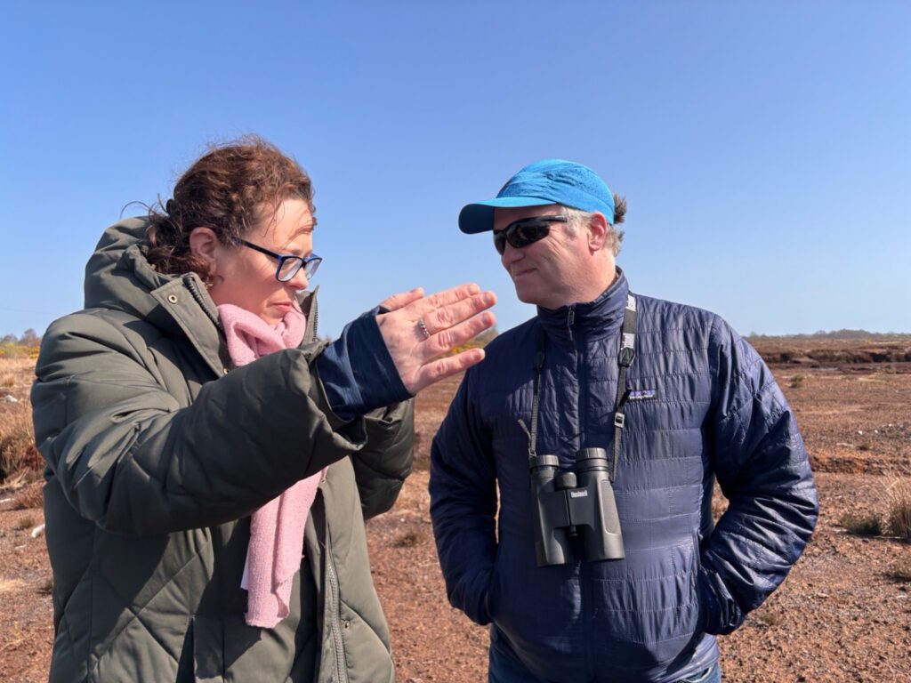 Photograph of Ciara Egan, Lemanaghan Bog Heritage and Conservation Group talking with Gearóid O’Foighil, Cloughjordan Community Development Group - Scohaboy Bog. (Photo Helen Shaw, April 2025).