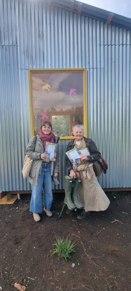 Two women standing beside Bog Bothy