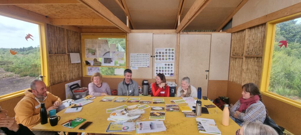 Photo of group of people sitting around table in  Bog Bothy