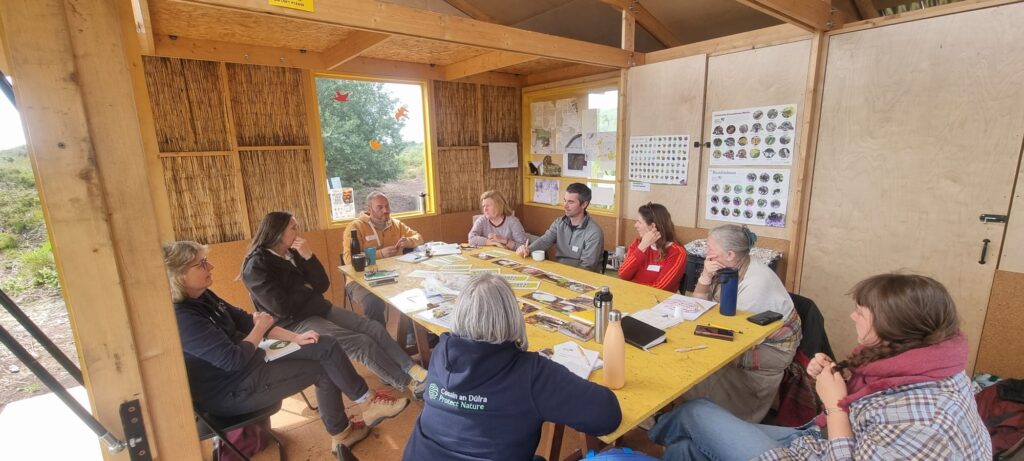 People sitting at table in Bog Bothy