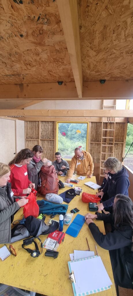 group of people standing at table in bog bothy