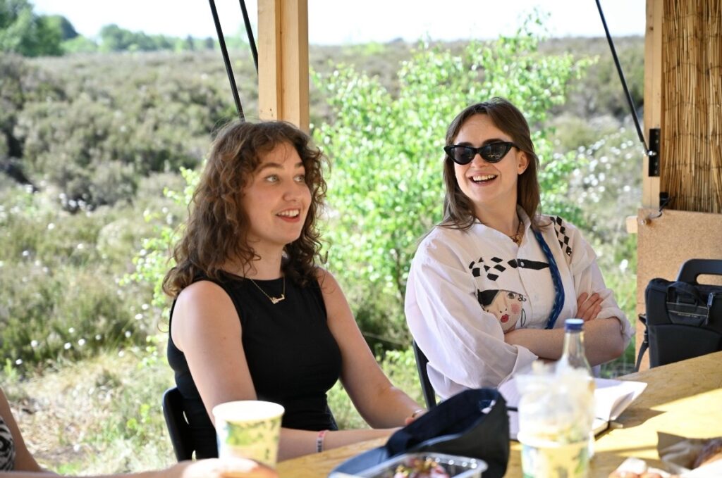 Evanna and Emily sitting at a table in the Bog Bothy 