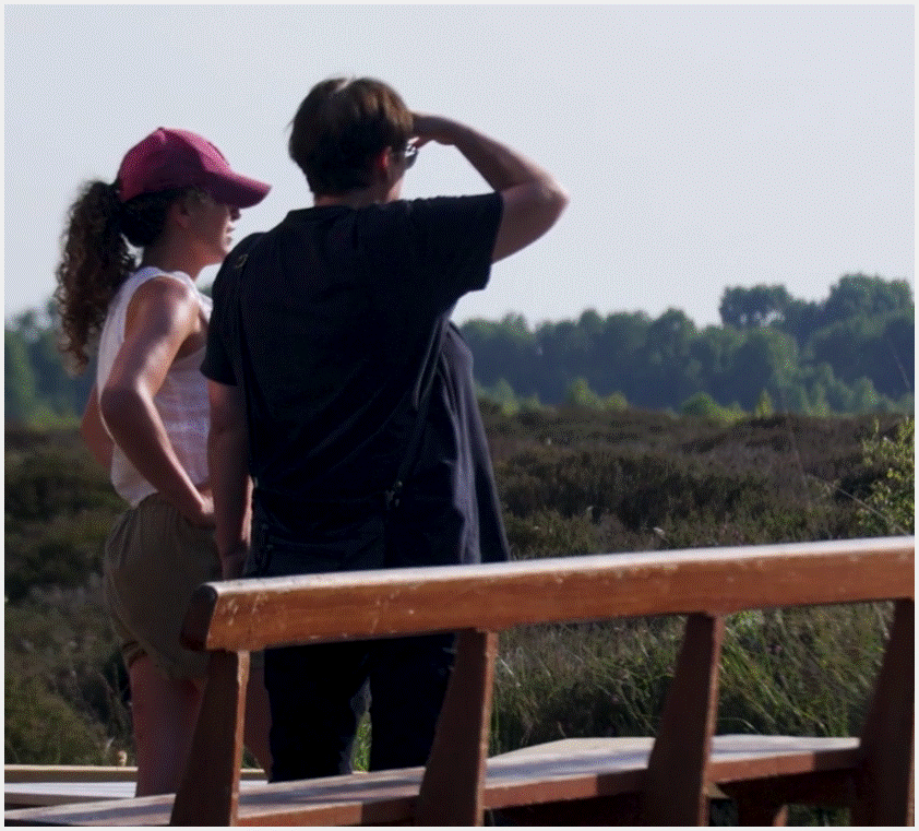 Two women, from behind, look out over the bog. 