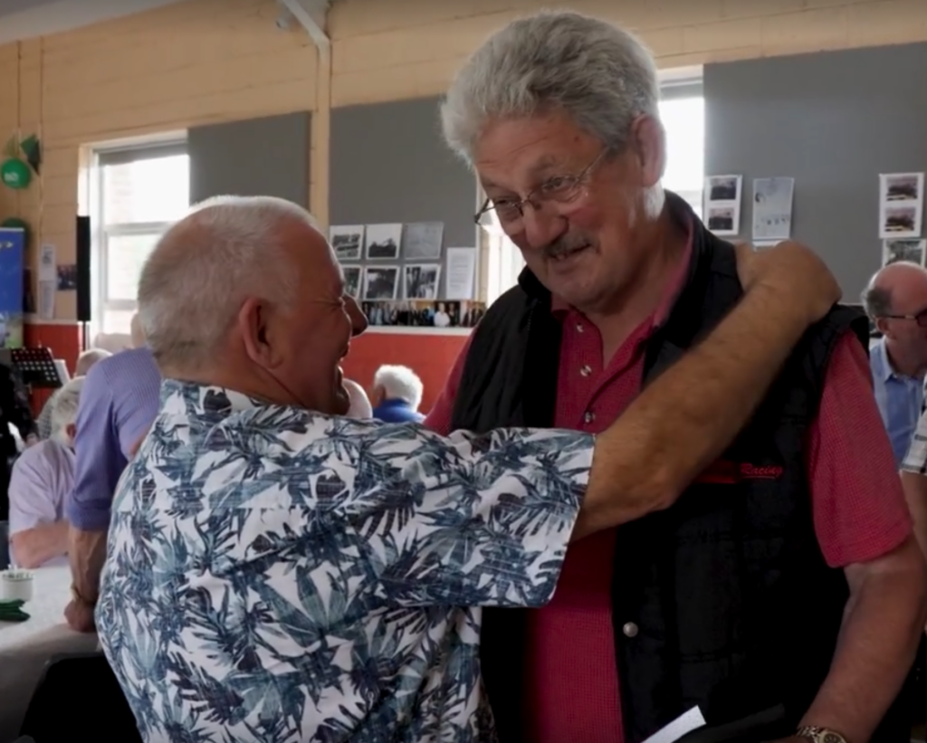Photograph of Seamóg greeting former colleagues at the June 27th reunion