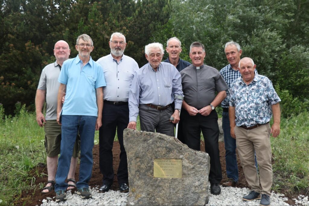Photograph of Tommy Bracken, Kevin Healy, Seamus Barron, Tom Cannon, Kevin Brazil, Fr P.J. Hughes, P.J. Murphy Seamóg Buckley at the memorial for the Boora workers