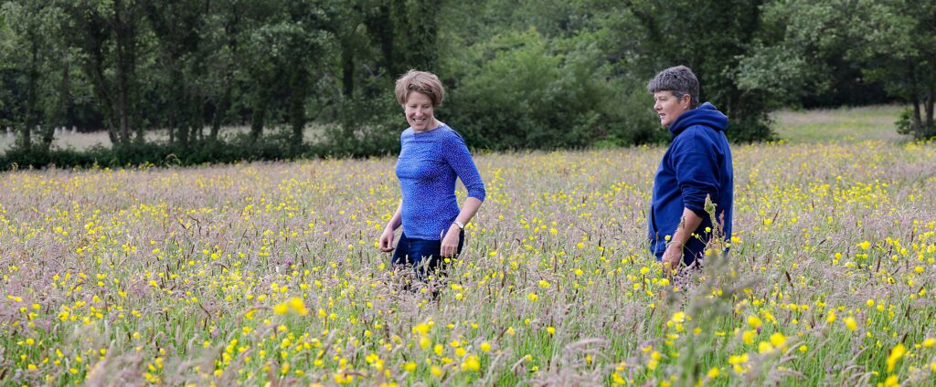 Two women walking through a field