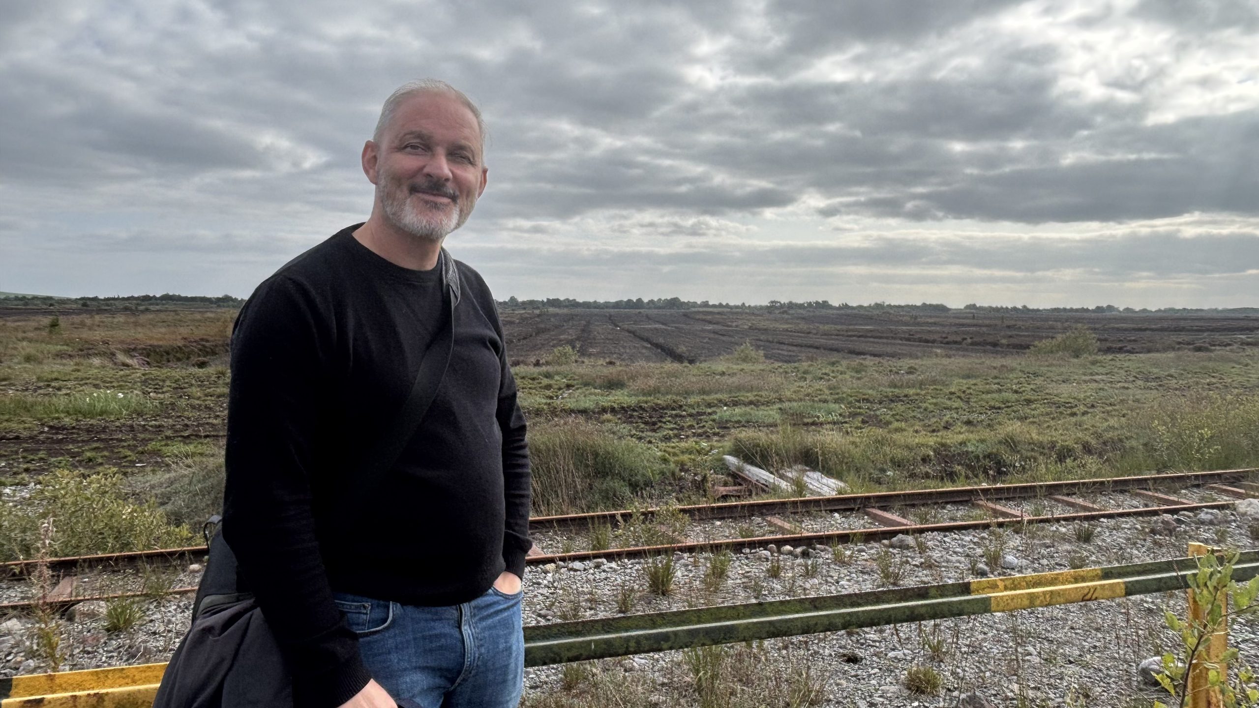 Photo: Archaelogist, Dr Michael Stanley, at Toar Bog beside disused Bord na Móna rail tracks (Helen Shaw)